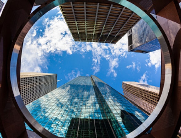 Tall building with mirrored sides viewed from below