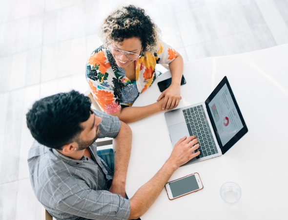 A man and a woman working on a laptop